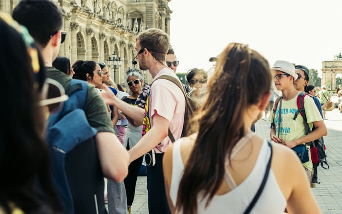 Guide leading a group of travellers through a historic city